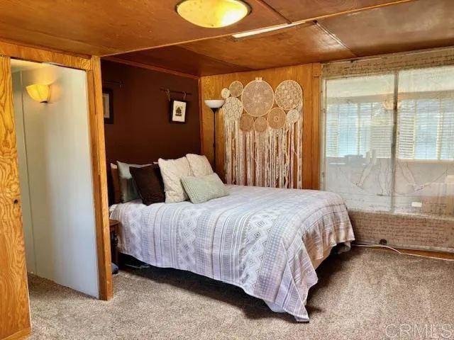 a bedroom with a bed and a mirror