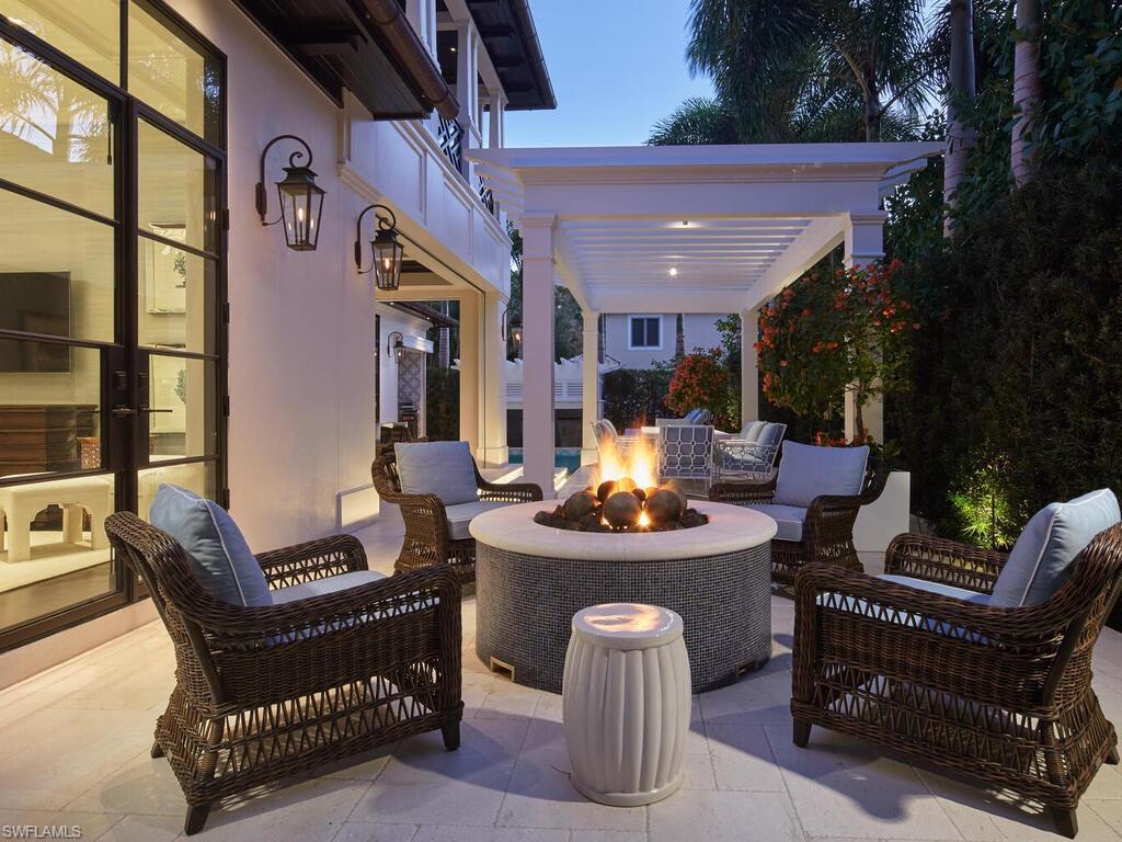 167 4th Street North Naples, FL 34102 - Photo 27 of 33 a view of a patio with table and chairs