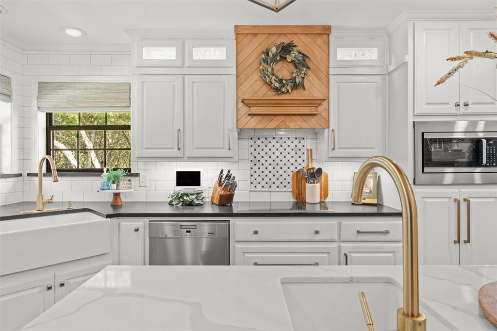 3050 Bosque Ridge Road Crawford, TX 76638 - Photo 11 of 40 a kitchen with stainless steel appliances granite countertop a sink and cabinets with wooden floor