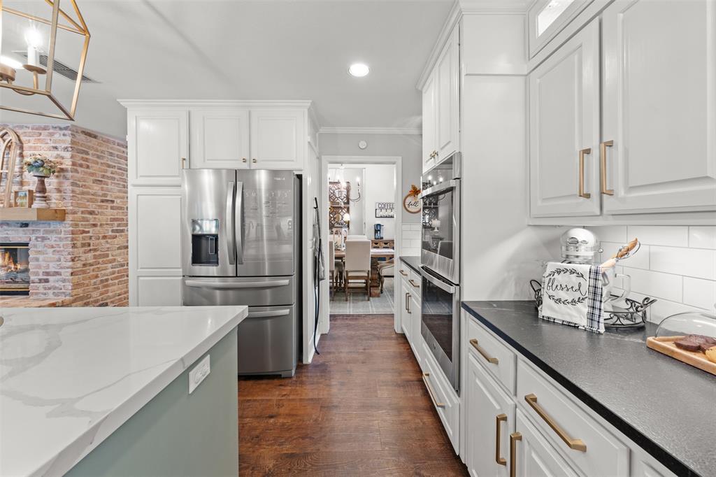 3050 Bosque Ridge Road Crawford, TX 76638 - Photo 12 of 40 a kitchen with refrigerator and cabinets