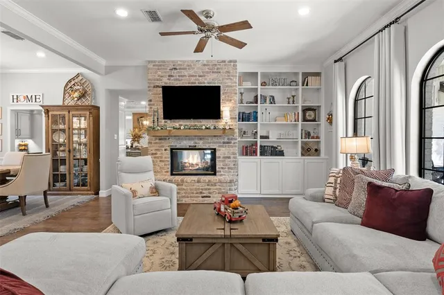a living room with furniture fireplace and flat screen tv