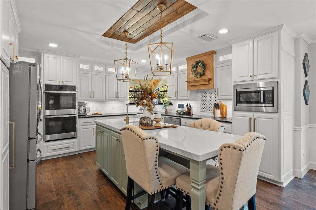 3050 Bosque Ridge Road Crawford, TX 76638 - Photo 10 of 40 a kitchen with stainless steel appliances a stove refrigerator sink and cabinets