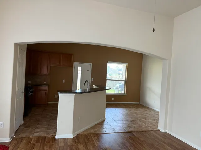 a view of a kitchen cabinets and wooden floor