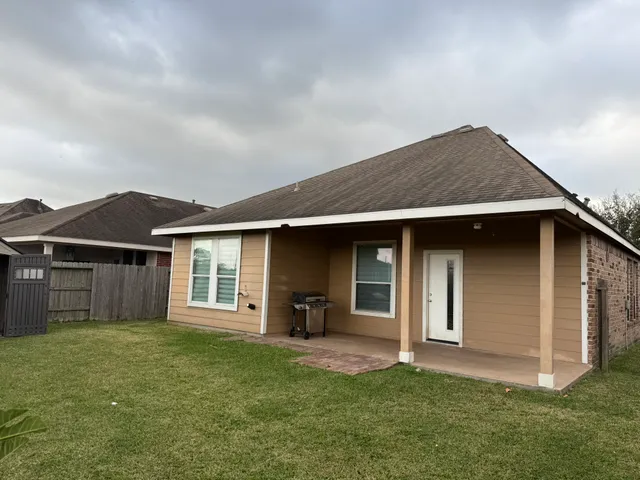 a backyard of a house with table and chairs