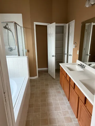 a bathroom with a tub sink and mirror