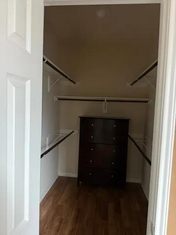 a room with a closet and wooden floor