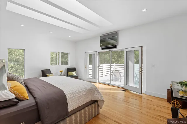 a bedroom with a large bed and a tv