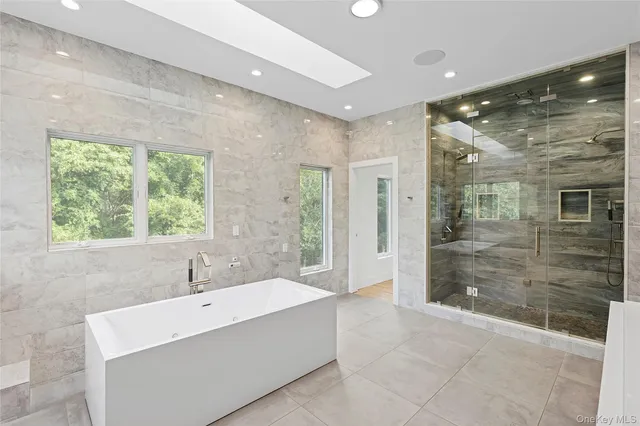 a bathroom with a bathtub and shower