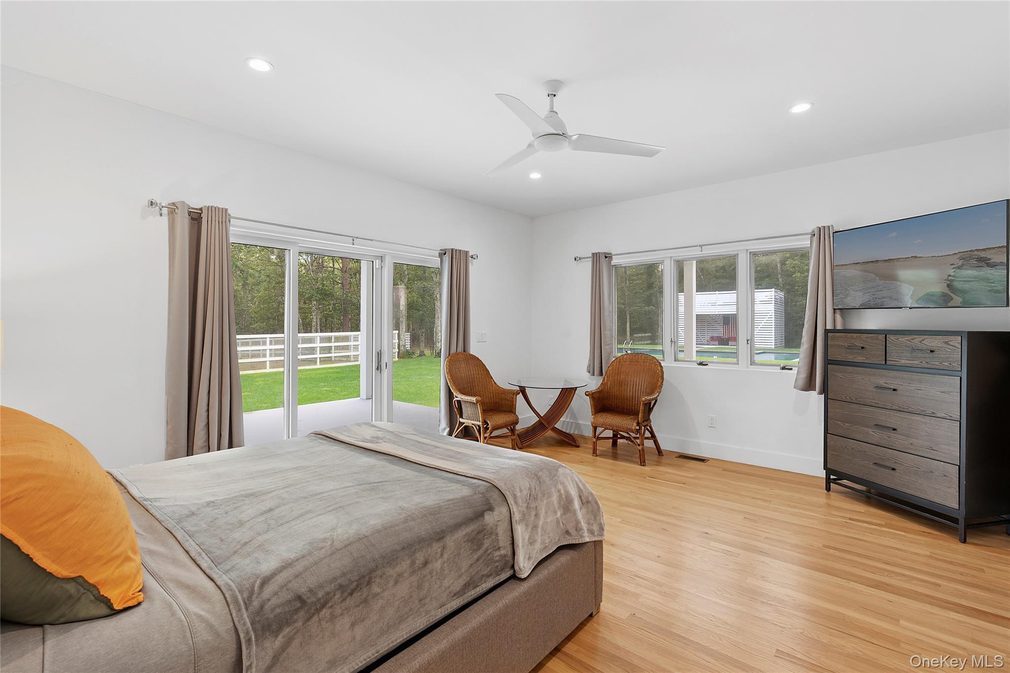 198 2 Holes Water Road East Hampton, NY 11937 - Photo 15 of 25 a bedroom with a bed and wooden floor