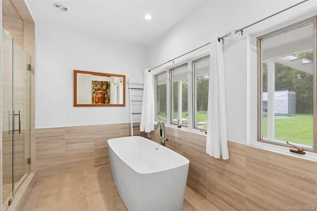 a spacious bathroom with a bathtub and a sink