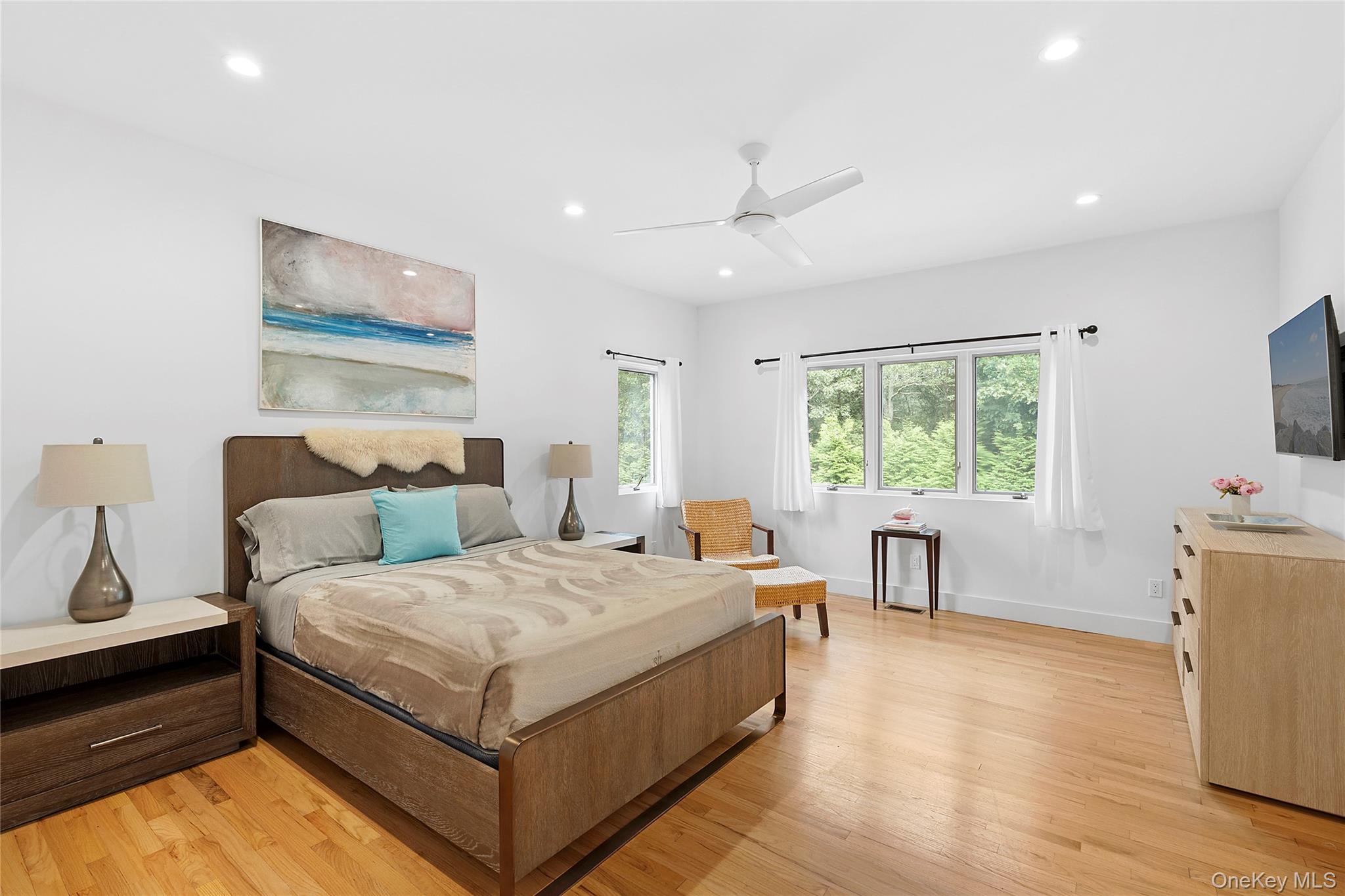 198 2 Holes Water Road East Hampton, NY 11937 - Photo 20 of 25 a bedroom with a bed and a flat screen tv