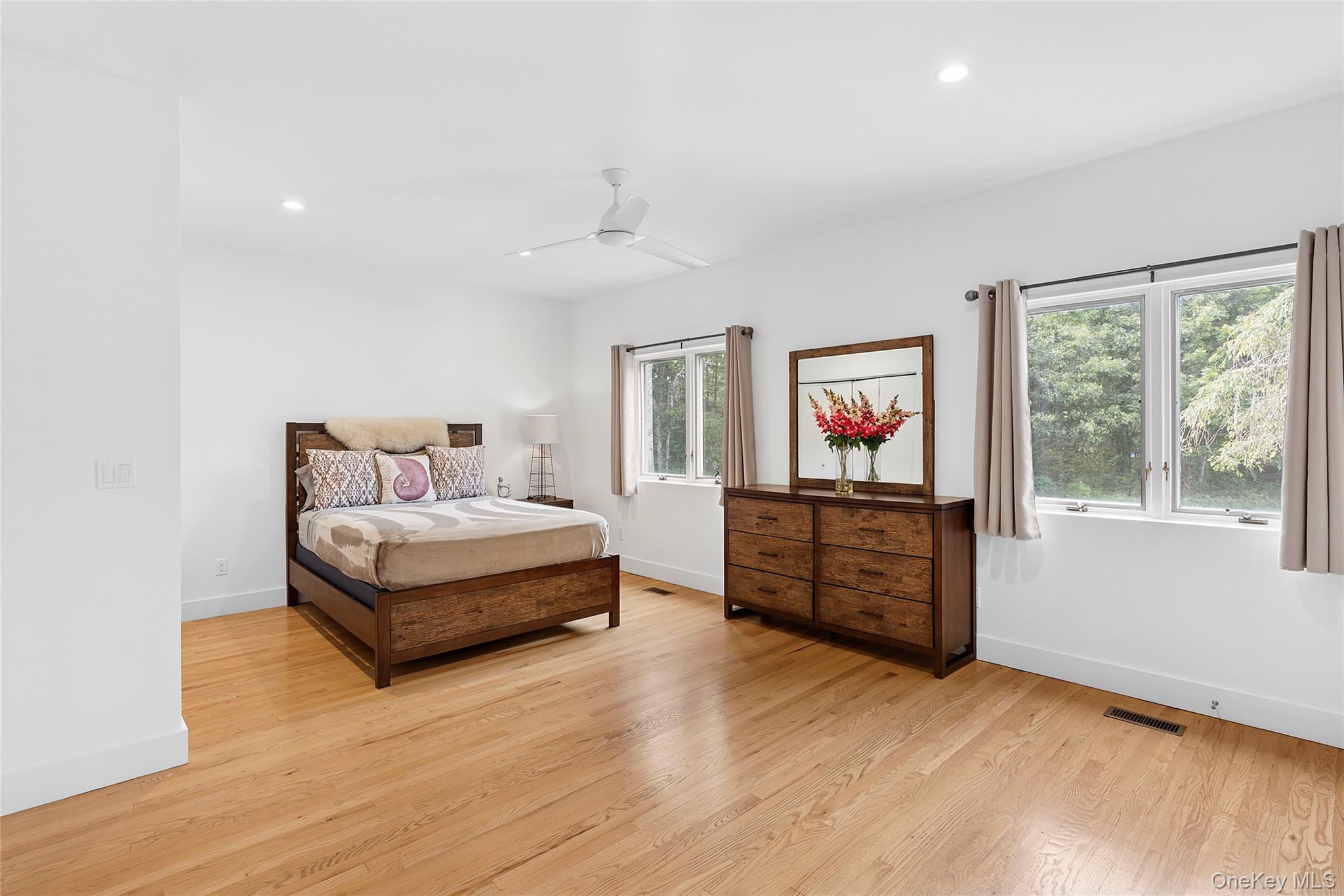 198 2 Holes Water Road East Hampton, NY 11937 - Photo 21 of 25 a spacious bedroom with a bed and a dresser
