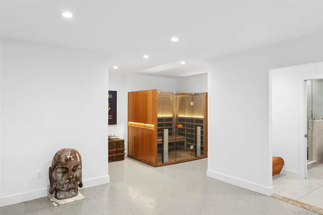 an empty room with furniture and gym equipment