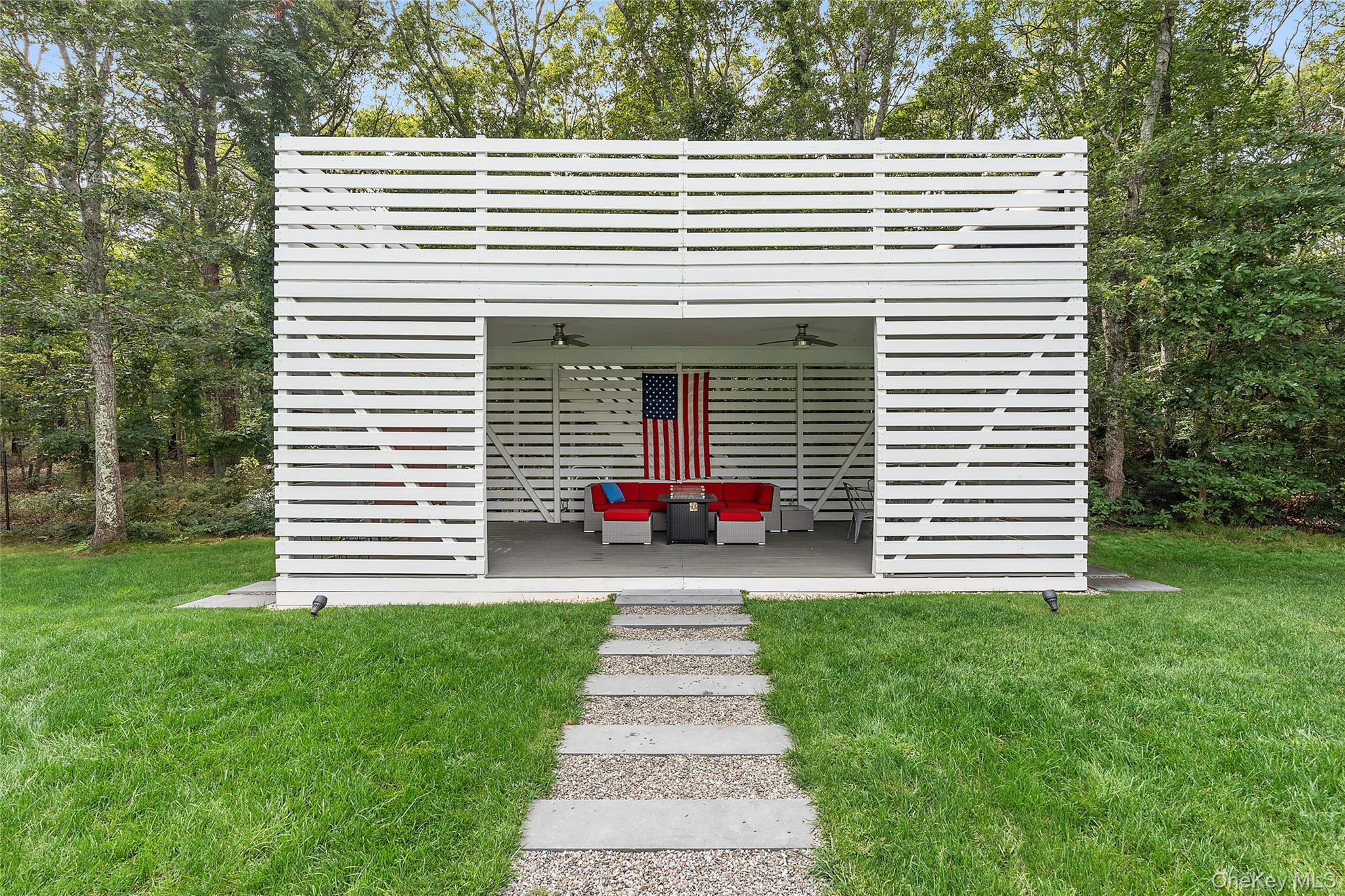 198 2 Holes Water Road East Hampton, NY 11937 - Photo 5 of 25 a front view of a house with a yard and trees