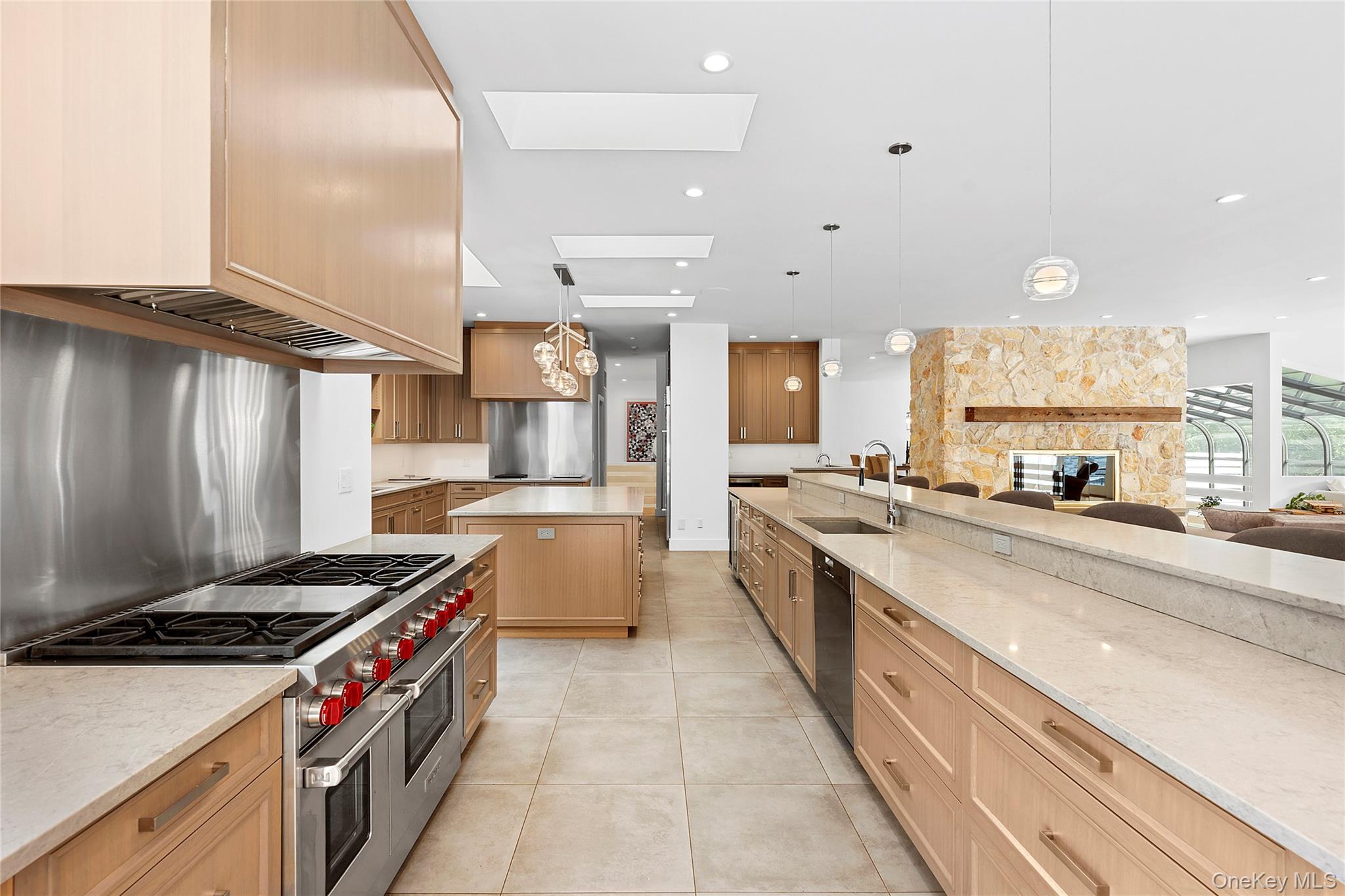 198 2 Holes Water Road East Hampton, NY 11937 - Photo 8 of 25 a large kitchen with stainless steel appliances granite countertop a large stove a sink dishwasher and white cabinets with wooden floor