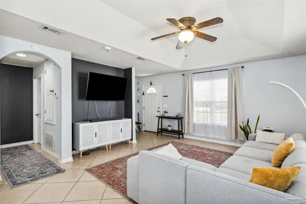 a living room with furniture and a flat screen tv