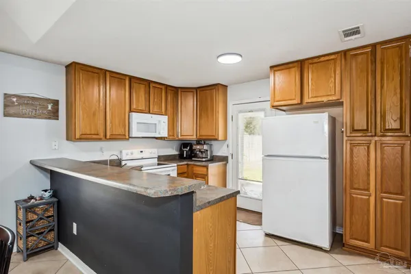 a white refrigerator freezer sitting in a kitchen