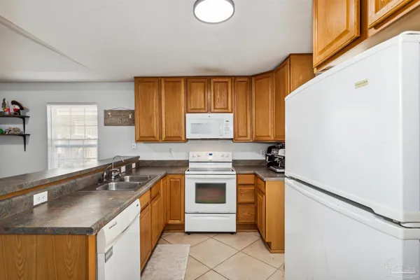 a kitchen with a sink stove and refrigerator