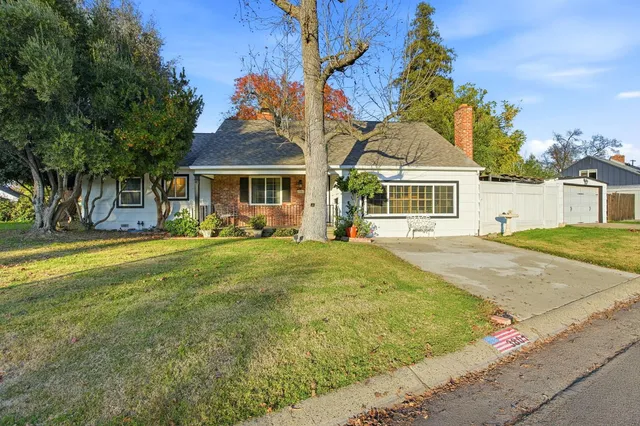 a front view of a house with a yard table and chairs
