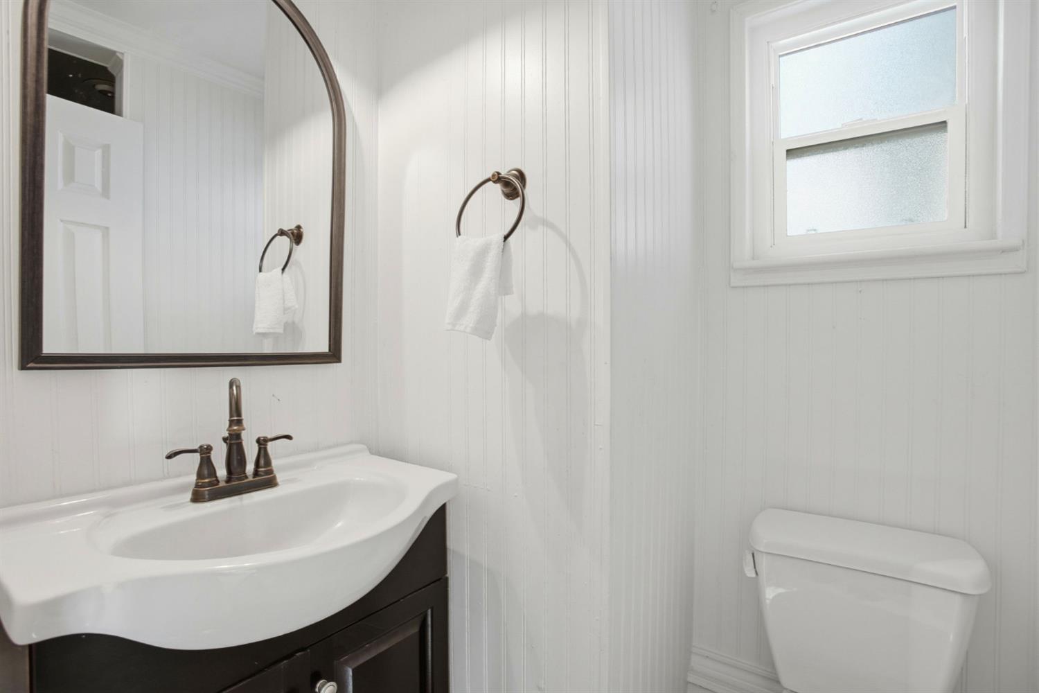 3801 Woodcrest Road Sacramento, CA 95821 - Photo 12 of 35 a bathroom with a sink toilet and mirror