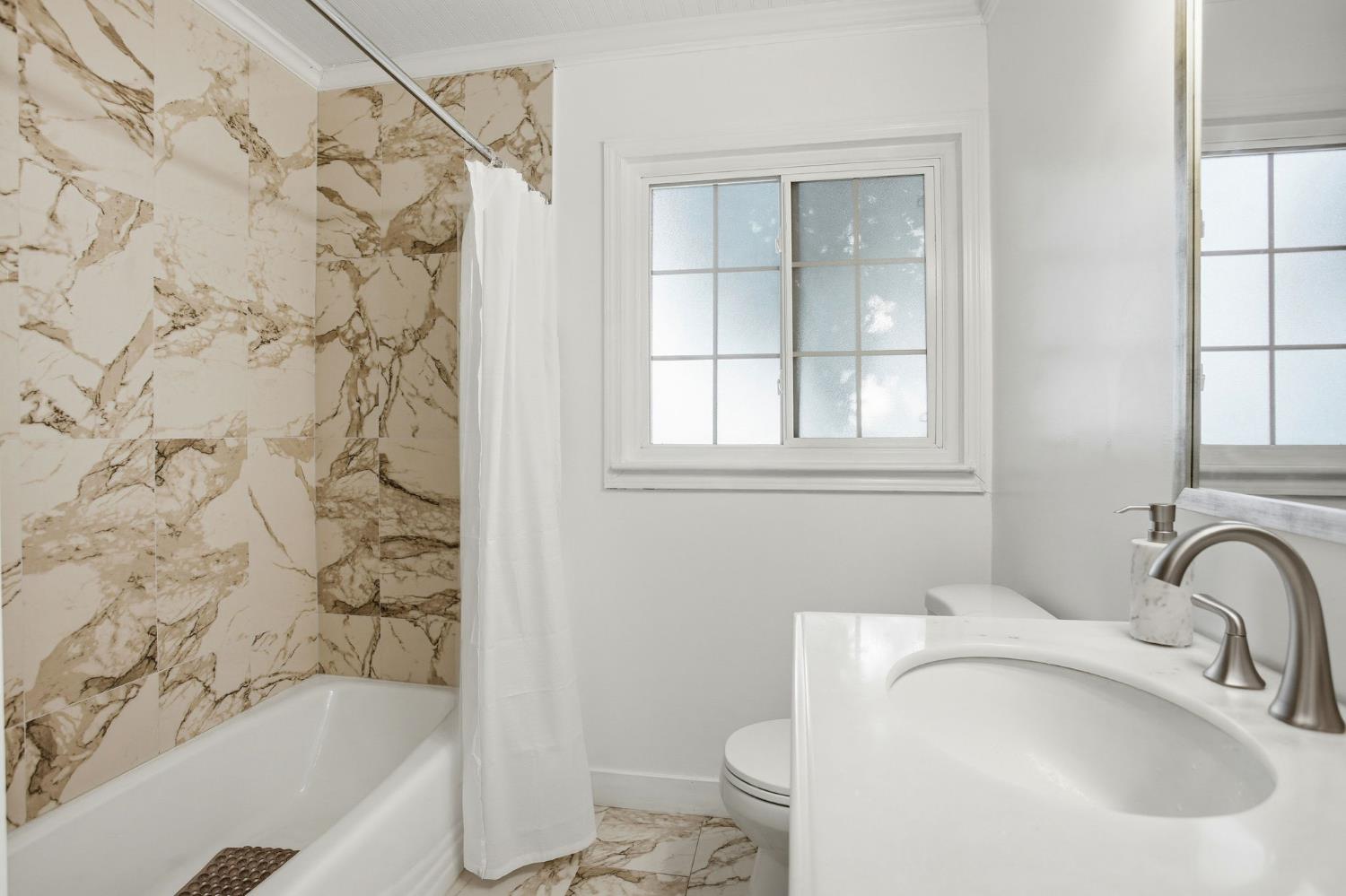 3801 Woodcrest Road Sacramento, CA 95821 - Photo 13 of 35 a bathroom with a sink toilet and shower