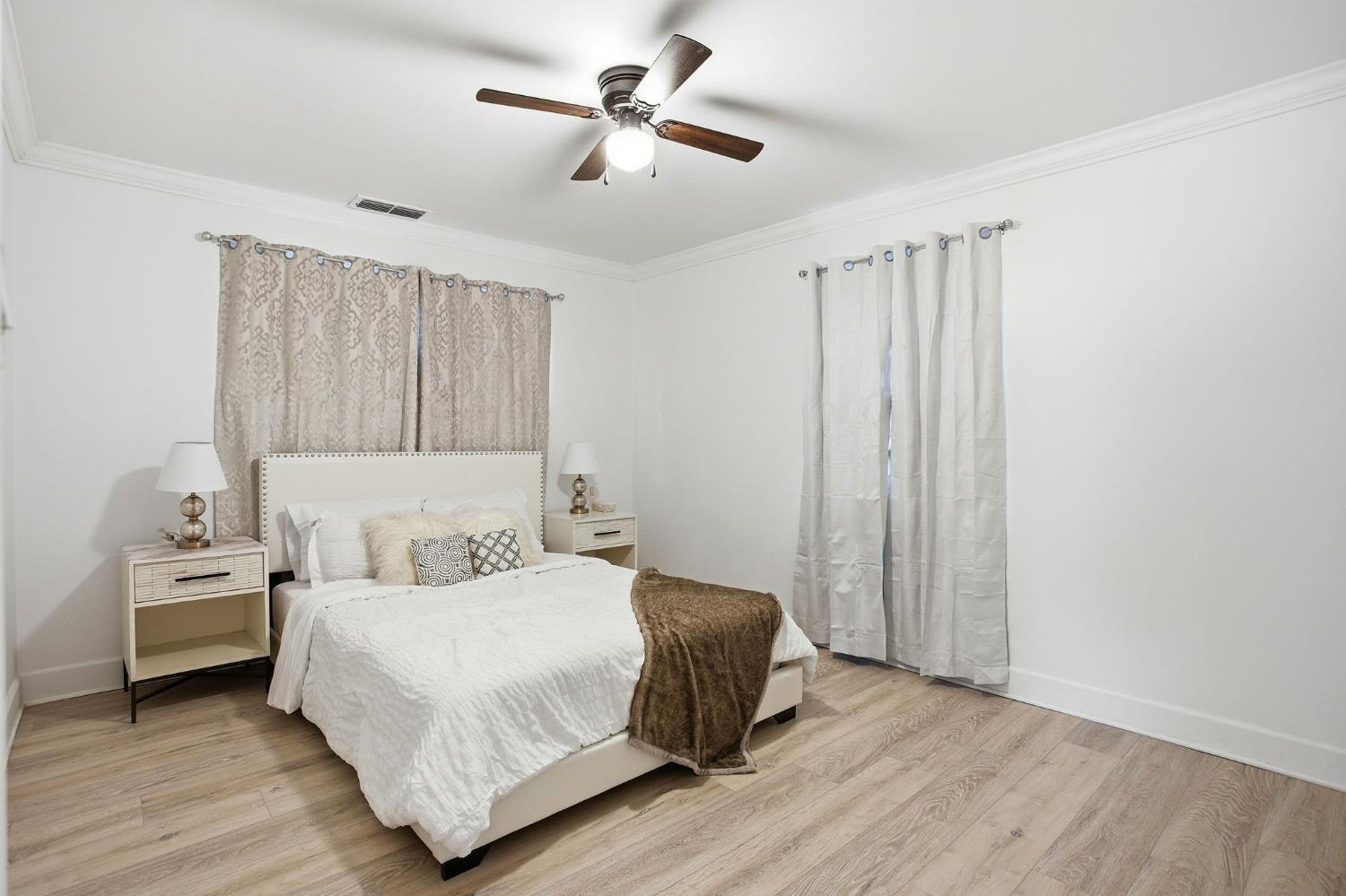 3801 Woodcrest Road Sacramento, CA 95821 - Photo 14 of 35 a bedroom with a bed and a chandelier