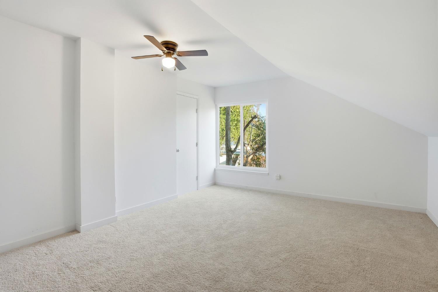 3801 Woodcrest Road Sacramento, CA 95821 - Photo 21 of 35 an empty room that has a window with a fan
