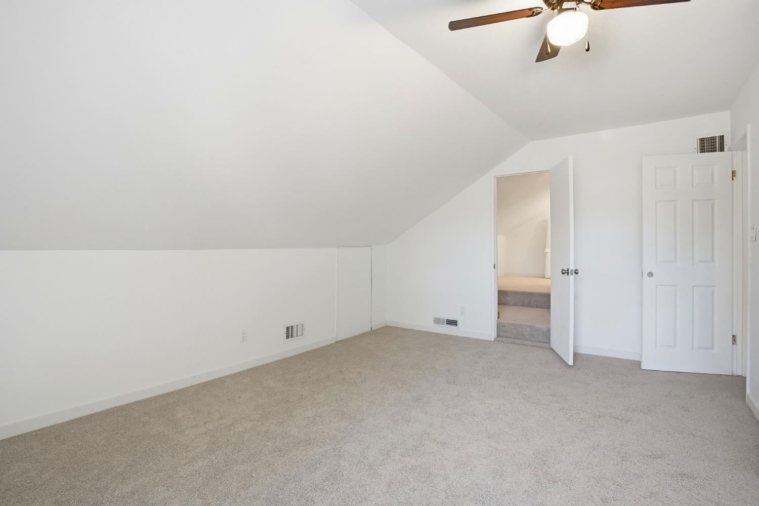 3801 Woodcrest Road Sacramento, CA 95821 - Photo 23 of 35 an empty room with a ceiling fan and carpet