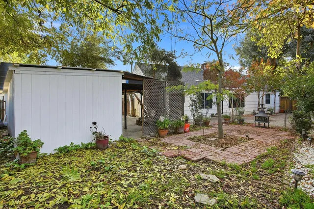 a backyard of a house with table and chairs