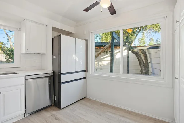 a white refrigerator freezer and a window