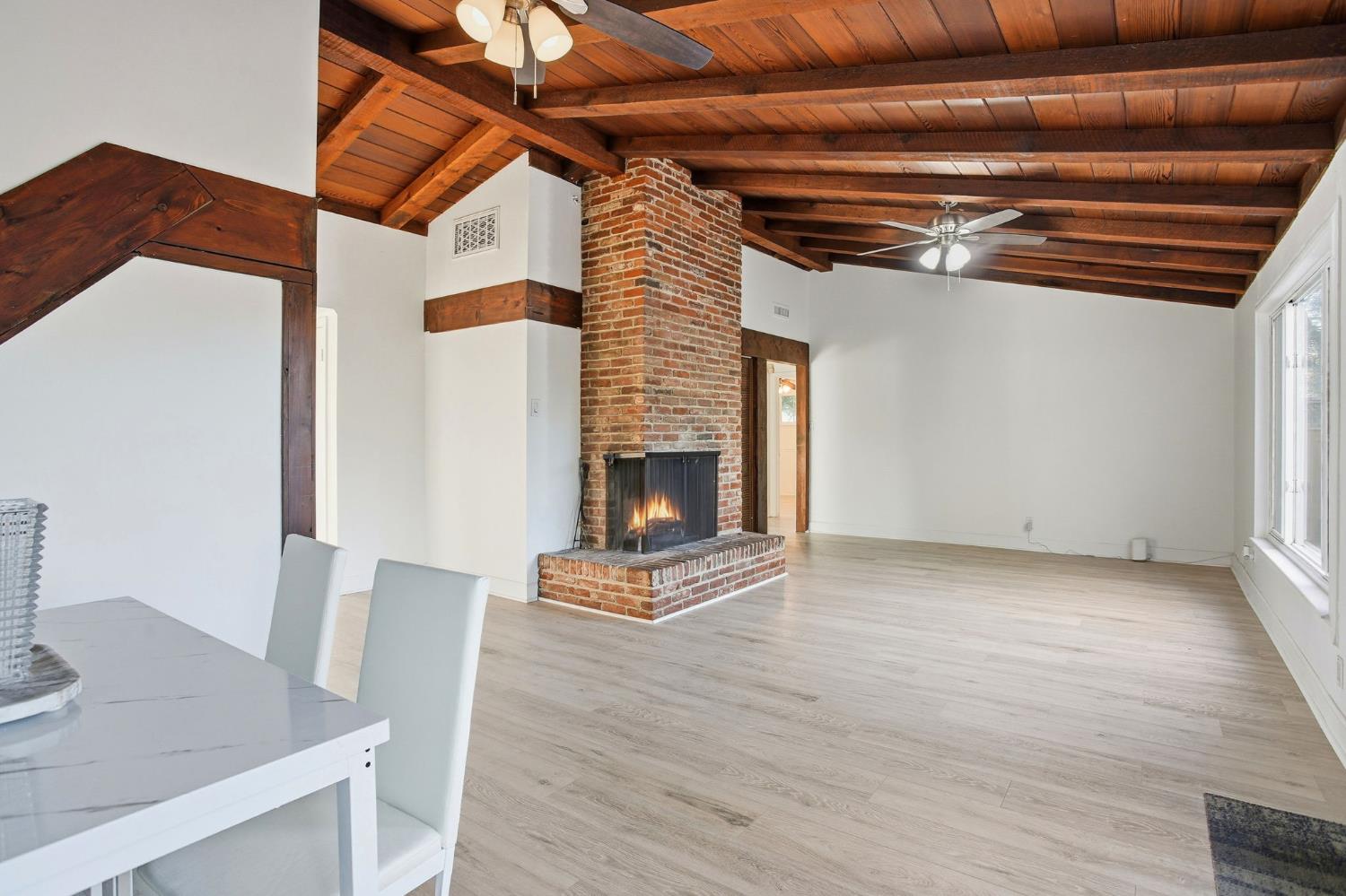 3801 Woodcrest Road Sacramento, CA 95821 - Photo 7 of 35 a view of an empty room with wooden floor and a fireplace