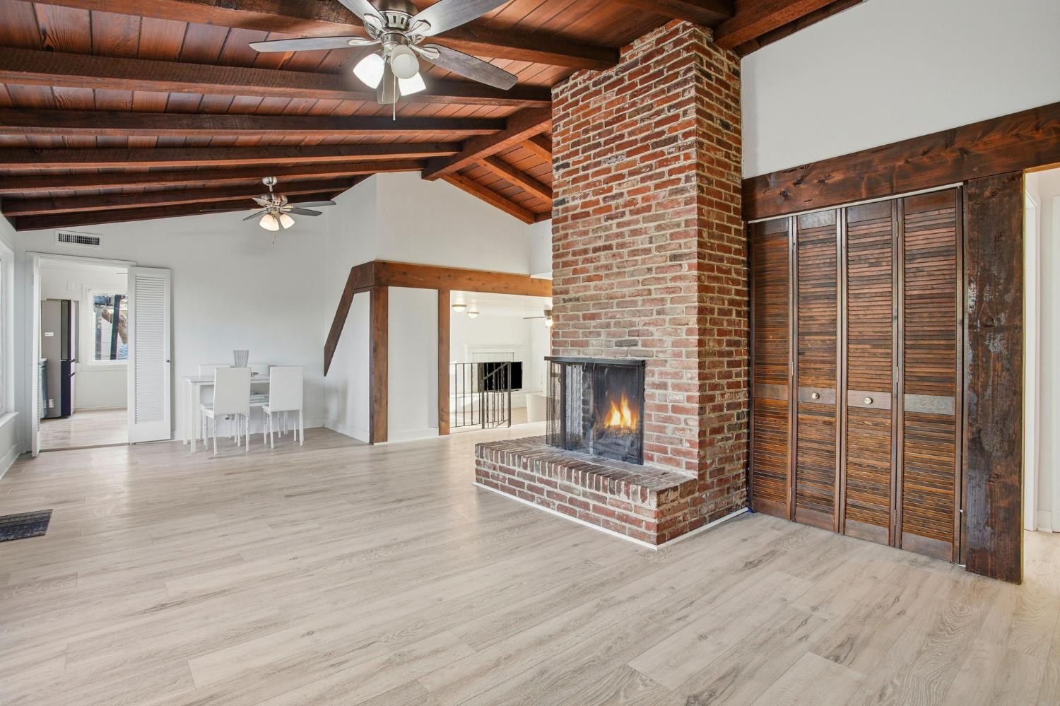 3801 Woodcrest Road Sacramento, CA 95821 - Photo 8 of 35 a view of an empty room with wooden floor and a fireplace