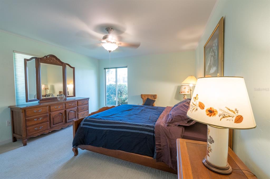 3300 Southwest 62nd Lane Gainesville, FL 32608 - Photo 12 of 34 a bedroom with a bed and wooden floor