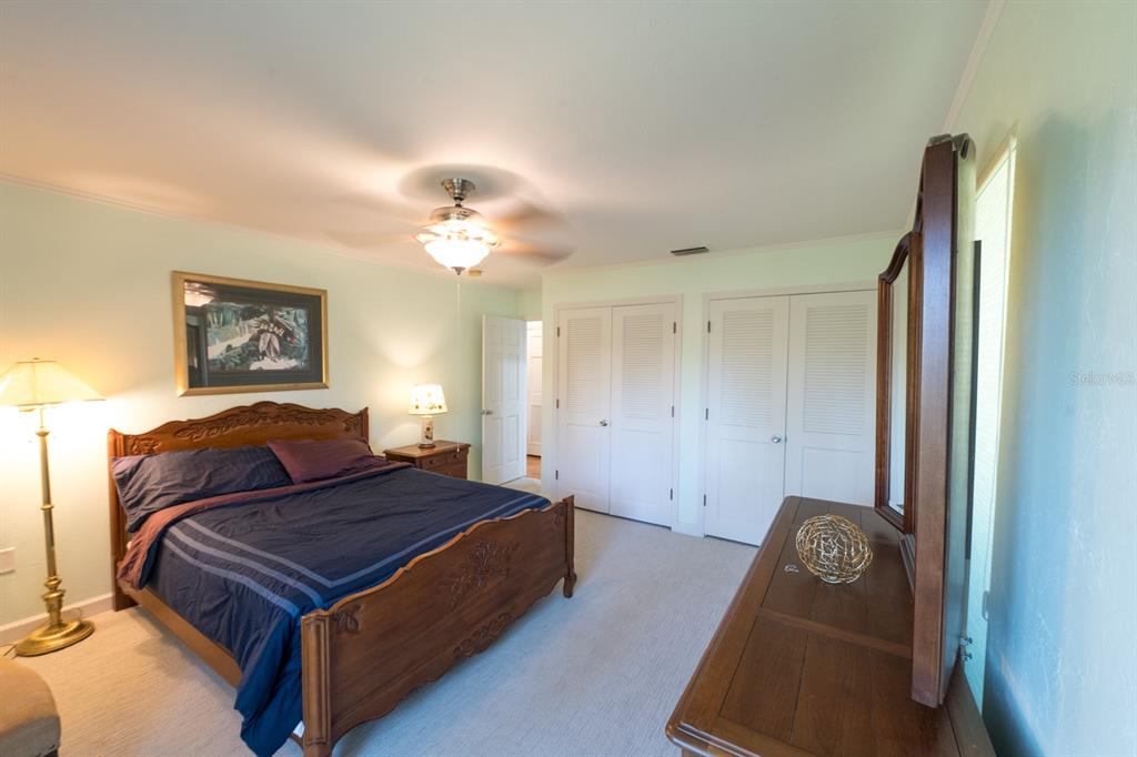 3300 Southwest 62nd Lane Gainesville, FL 32608 - Photo 13 of 34 a bedroom with a bed and a chandelier