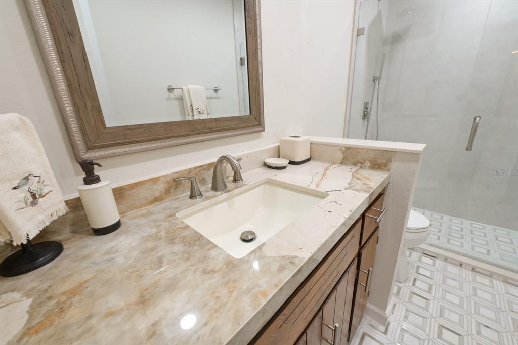 3300 Southwest 62nd Lane Gainesville, FL 32608 - Photo 16 of 34 a bathroom with a granite countertop sink and a mirror
