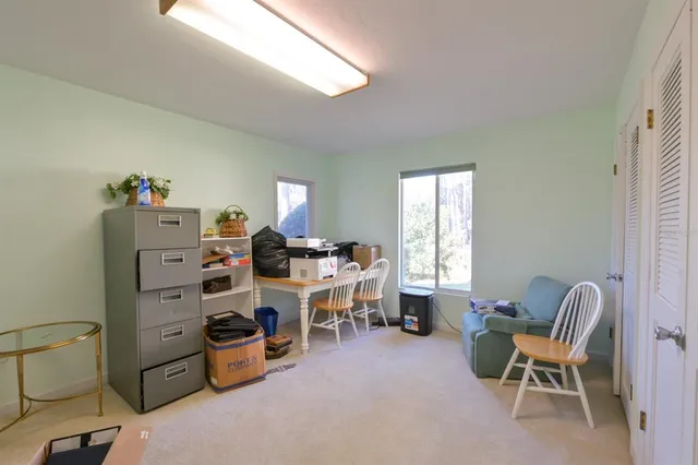 a living room with furniture and a floor to ceiling window