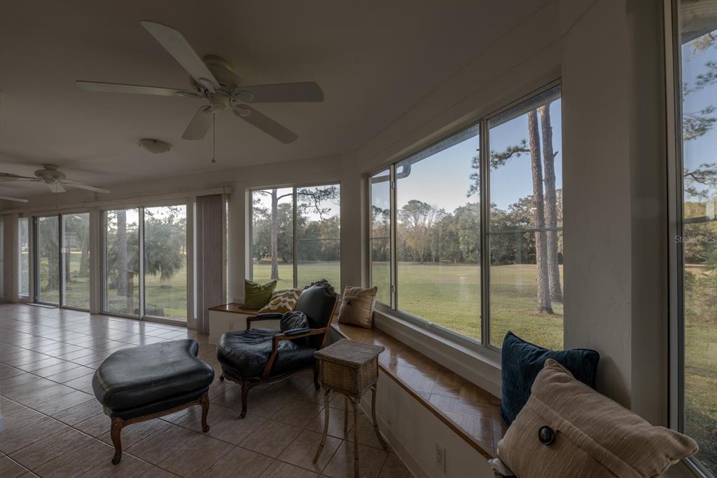 3300 Southwest 62nd Lane Gainesville, FL 32608 - Photo 18 of 34 a living room with furniture and a floor to ceiling window