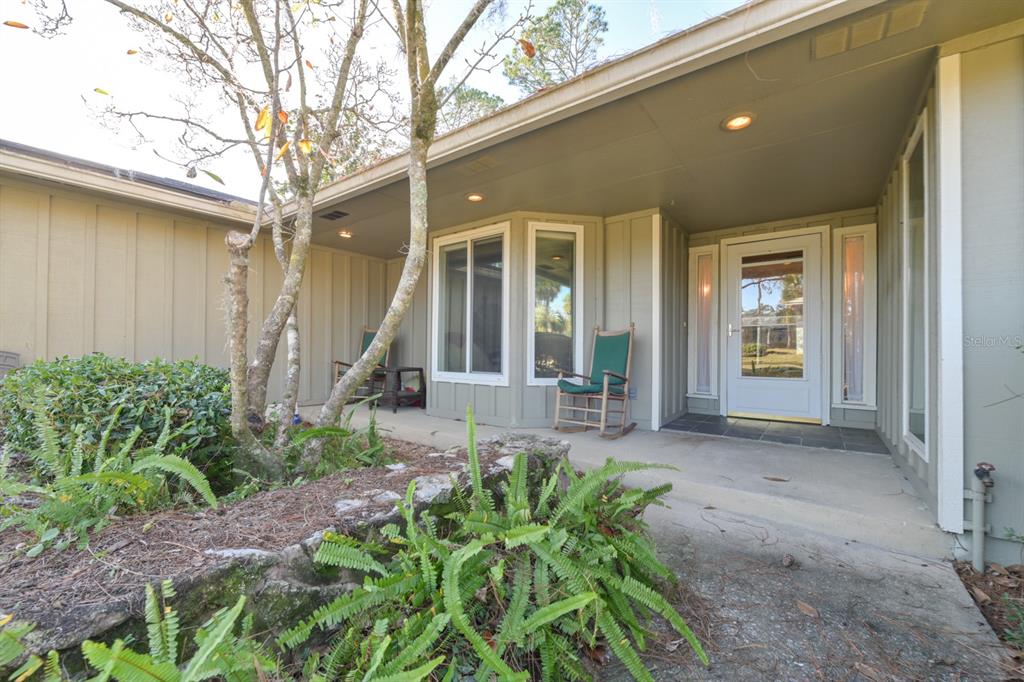 3300 Southwest 62nd Lane Gainesville, FL 32608 - Photo 2 of 34 a front view of a house with a large windows and plants
