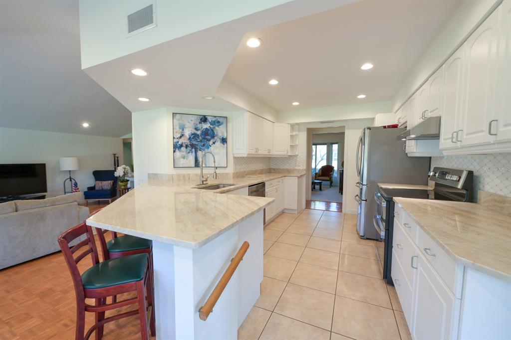 3300 Southwest 62nd Lane Gainesville, FL 32608 - Photo 21 of 34 a large kitchen with a large counter top appliances and cabinets