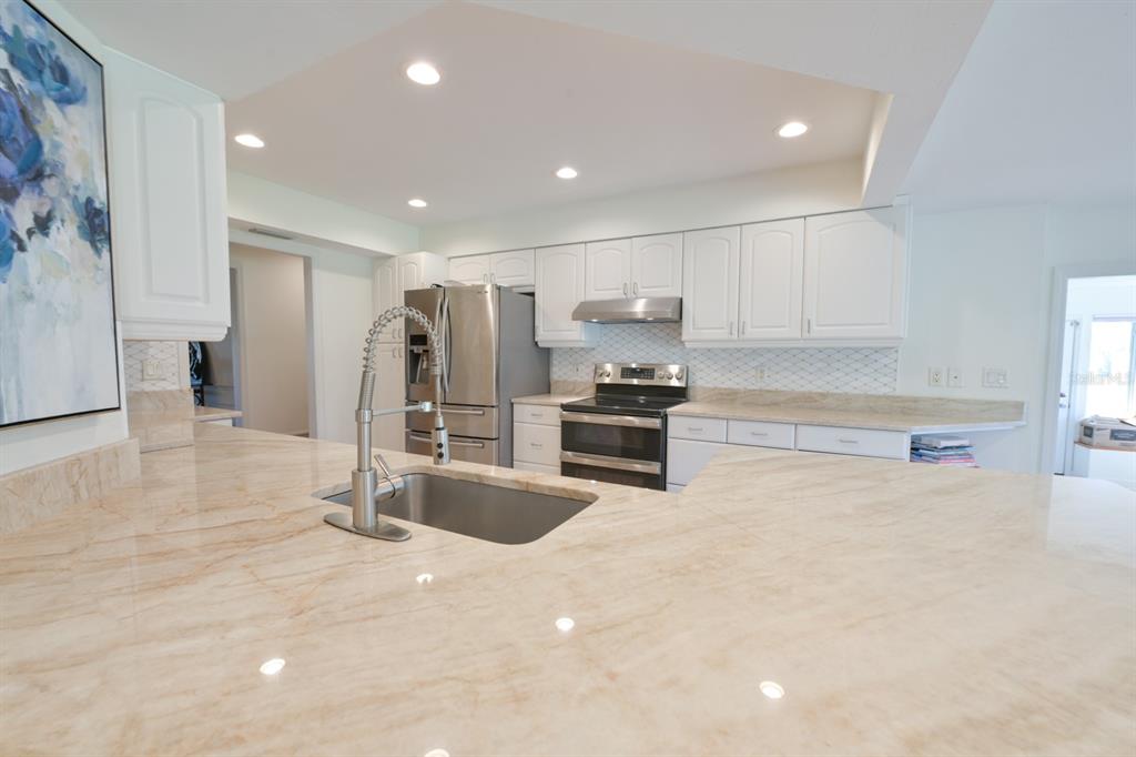 3300 Southwest 62nd Lane Gainesville, FL 32608 - Photo 22 of 34 a kitchen with stainless steel appliances a refrigerator and a sink