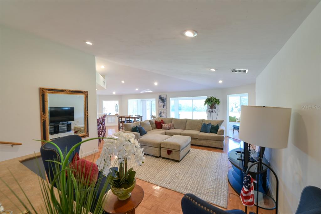 3300 Southwest 62nd Lane Gainesville, FL 32608 - Photo 6 of 34 a living room with furniture potted plant and a flat screen tv
