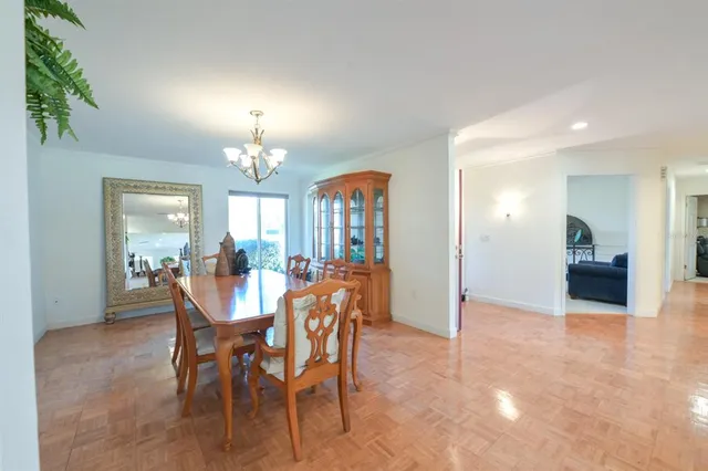 a view of a dining room with furniture and chandelier