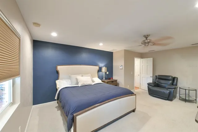 a bedroom with a bed and ceiling fan