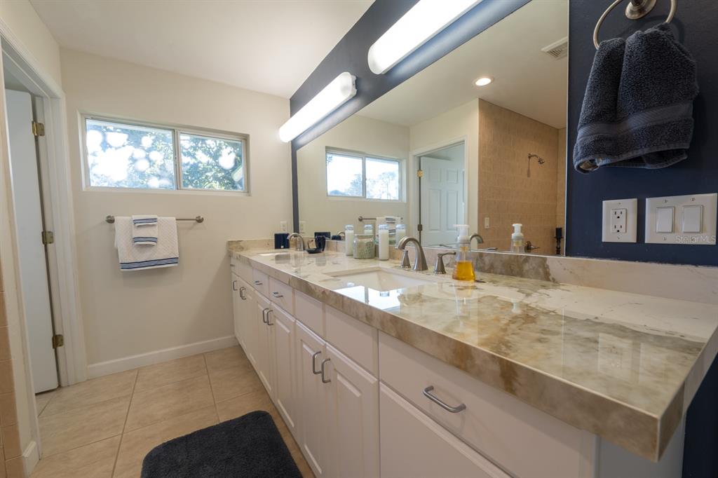 3300 Southwest 62nd Lane Gainesville, FL 32608 - Photo 9 of 34 a bathroom with a sink double vanity and a mirror