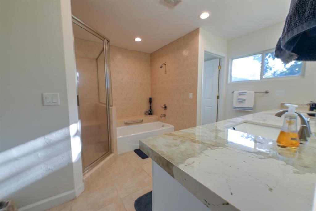 3300 Southwest 62nd Lane Gainesville, FL 32608 - Photo 10 of 34 a bathroom with a granite countertop sink and a mirror
