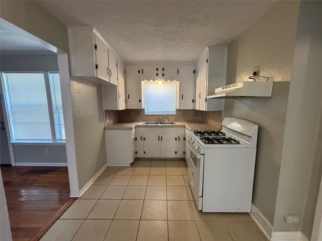 a kitchen with stainless steel appliances a stove a refrigerator and a sink