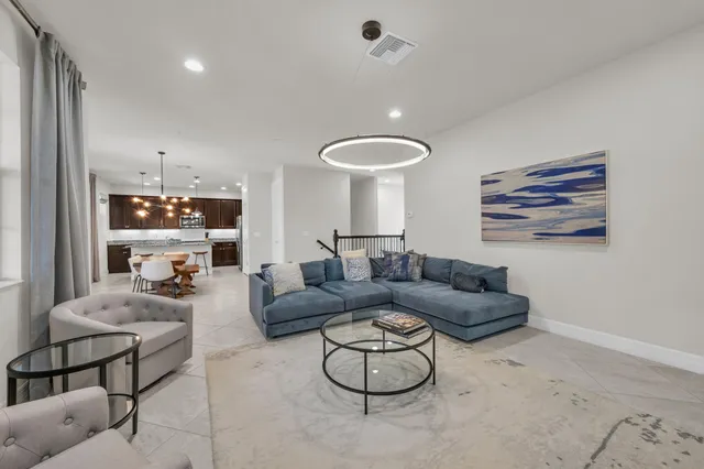 a living room with furniture and a to ceiling window