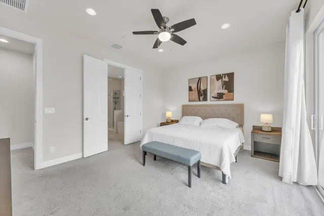 a bedroom with a bed and a ceiling fan