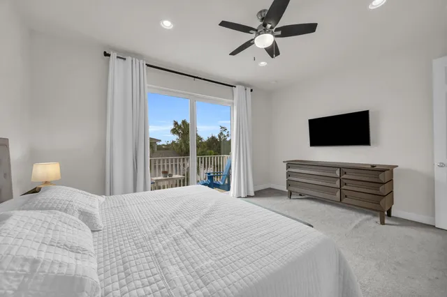 a bedroom with a bed tv and a window