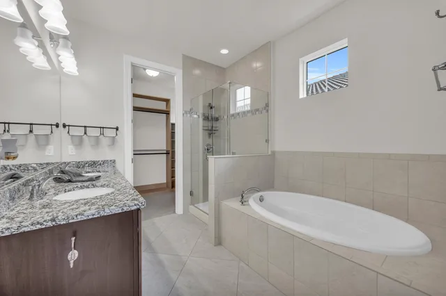 a bathroom with a granite countertop sink a toilet and shower